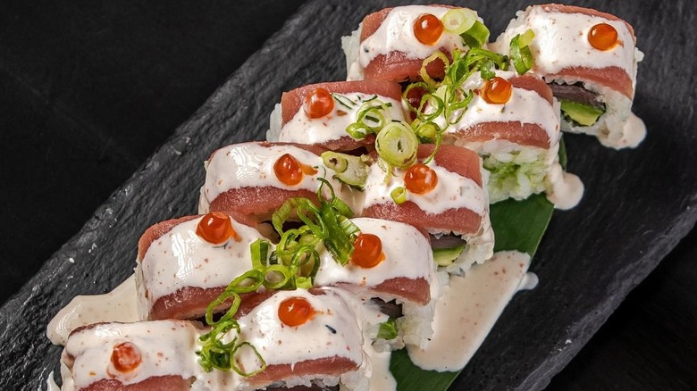 Top view of tuna rolls on black plate