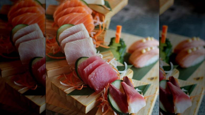Plated salmon and tuna sashimi with cucumber and carrot slices