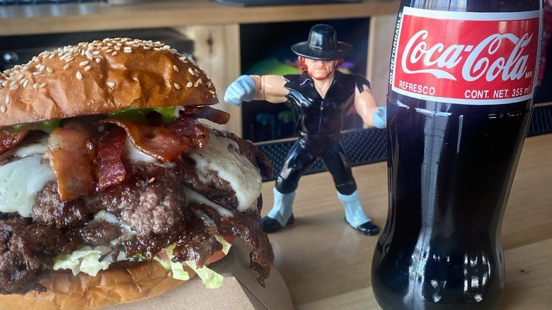 Tombstone burger next to The Undertaker action figure and Coke bottle
