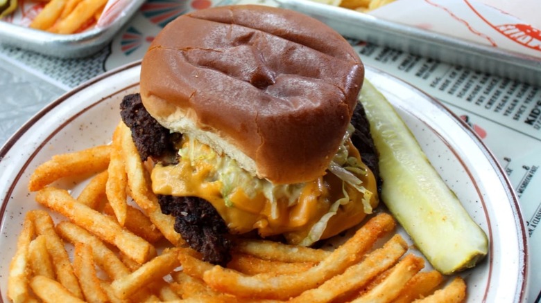Burger with fries and a pickle