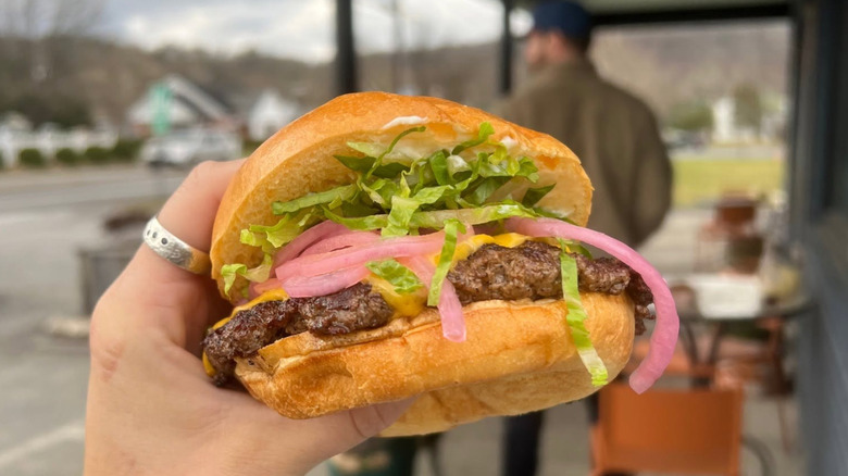 Person holding a burger
