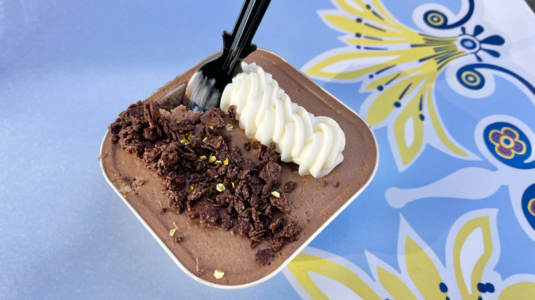 Close-up of chocolate cake from Jolly Holiday against a blue decorative background