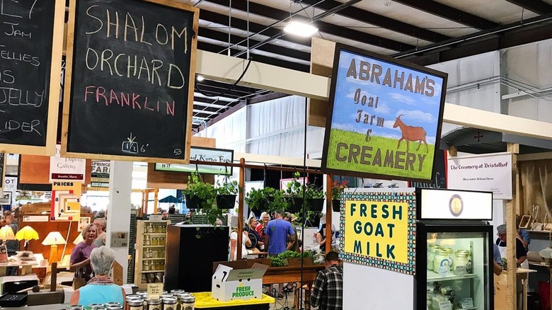 Goat milk for sale at farmers market located inside a building