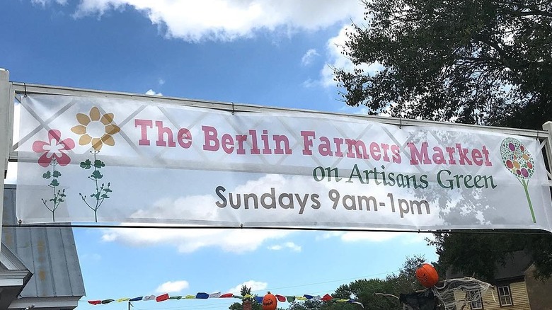 Berlin Farmers Market banner stretching above market with Halloween decorations