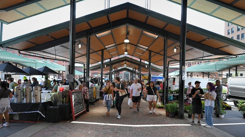 Folks walking under sheltered farmers market and chatting