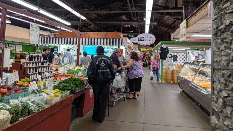 Shoppers perusing vegetables at indoor market