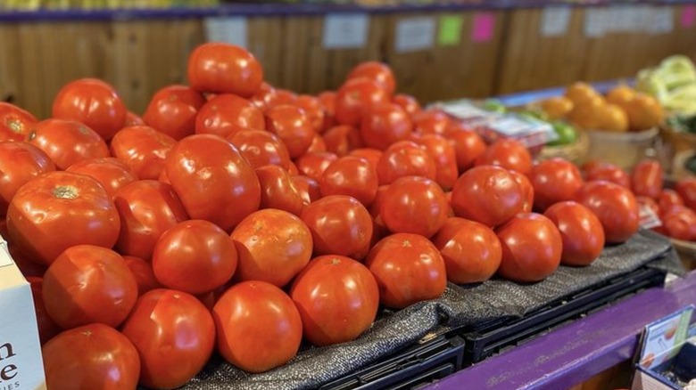 Tomatoes for sale alongside other produce at Capitol Market