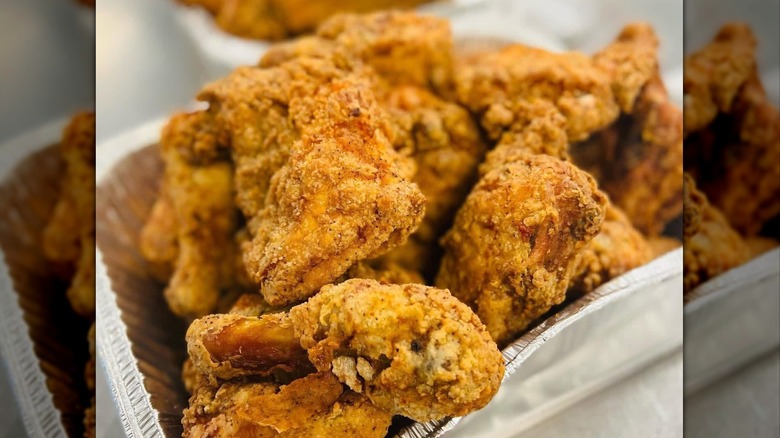 Close-up of aluminum tray container of fried chicken