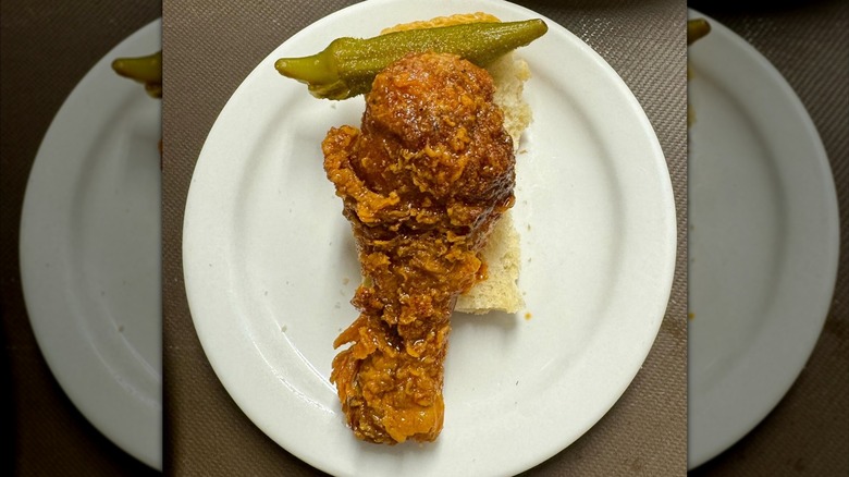 Close-up of fried chicken leg on white plate