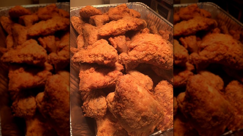 Close-up of fried chicken in aluminum foil pan