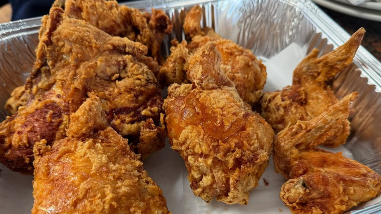 Close-up of hand tearing open fried chicken