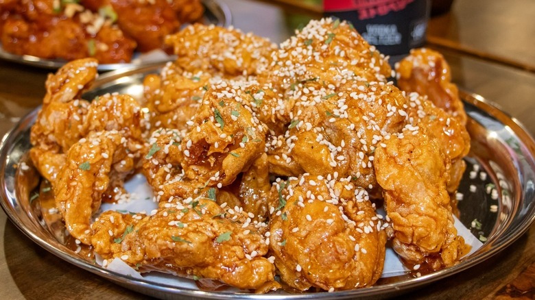 Pile of fried chicken on piece of paper on plate