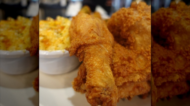 Close-up of fried chicken leg and thigh on plate