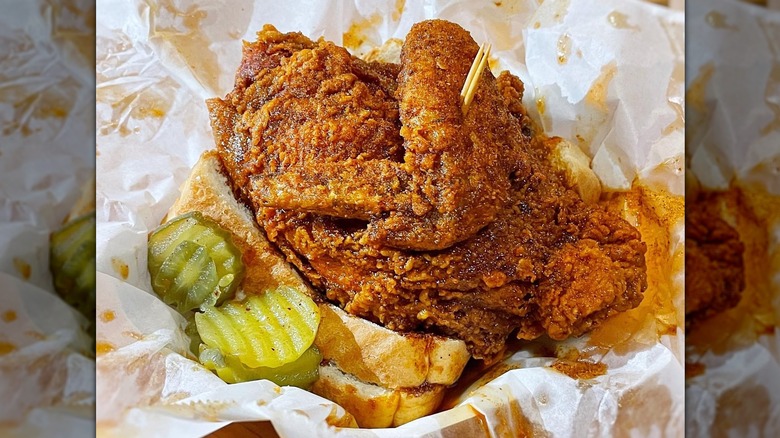 Close-up of basket of fried chicken and pickle slices