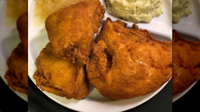 Close-up shot of fried chicken on white plate