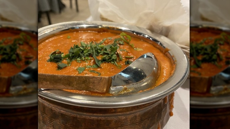 Butter chicken in copper serving bowl