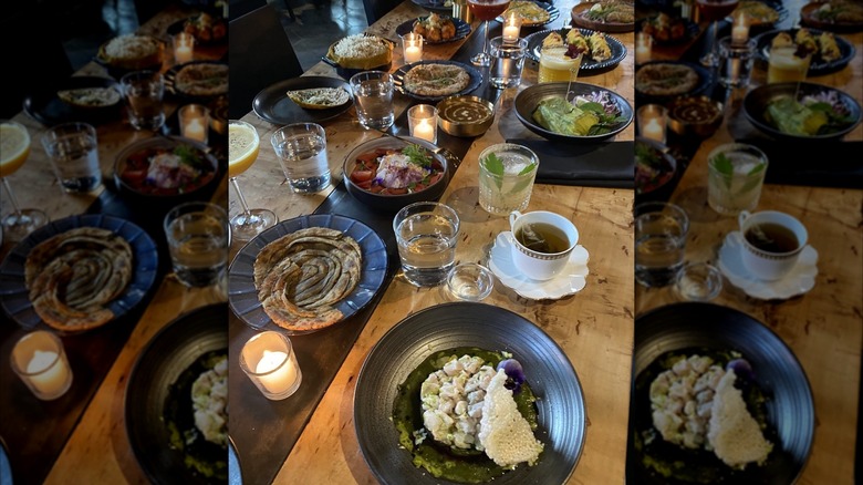 Indian food on black plates on wooden table