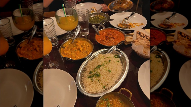 Indian dinner food spread out on a wooden table