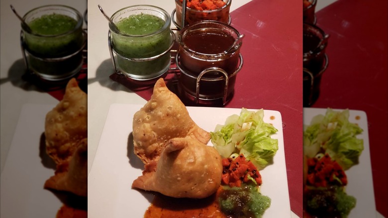 Samosas with three jars of chutneys