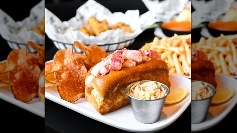 Lobster roll with fries on plate at Row 34 Seaport