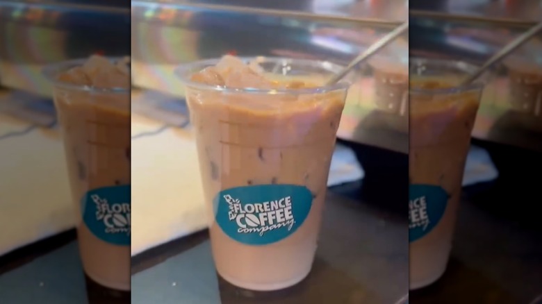 Iced pumpkin spice latte in plastic to-go cup with Florence Coffee Co. sticker