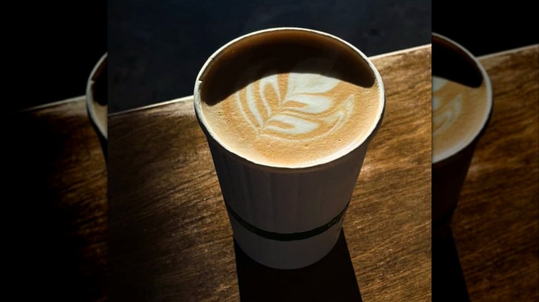 Fall special latte in to-go cup on table
