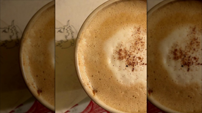 Overhead shot of pumpkin spice latte dusted with spice