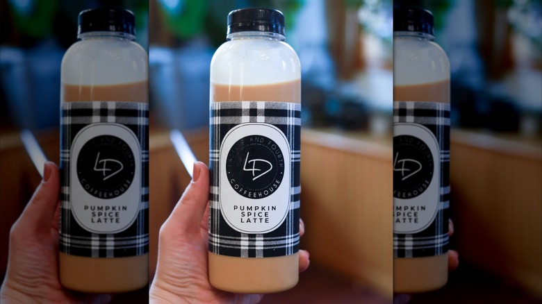Hand holding bottled pumpkin spice latte