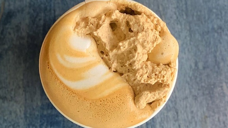Overhead shot of pumpkin latte topped with housemade whip