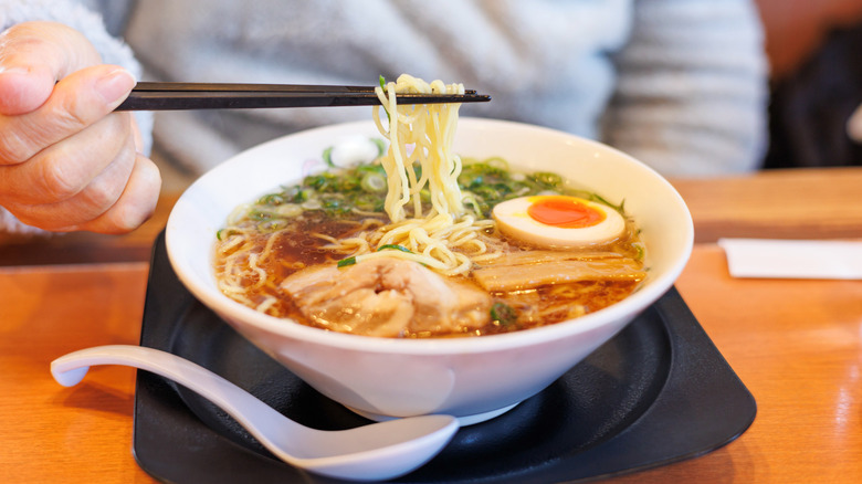 Eating ramen with chopsticks