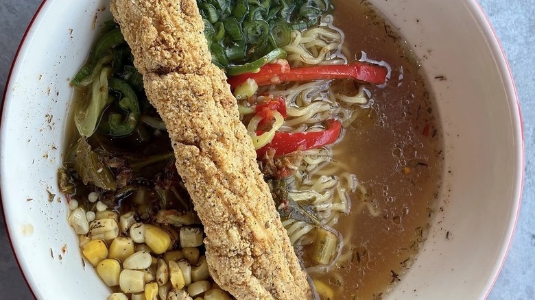 Ramen with fried red snapper, Cajun chicken broth, charred corn, bonito greens, hot peppers