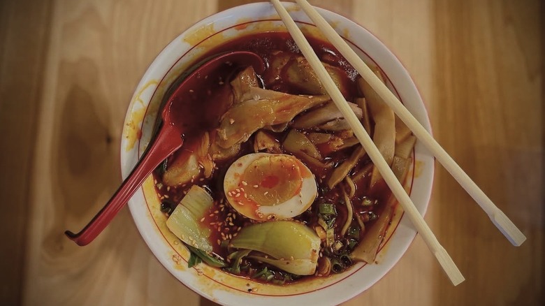 Ramen with chicken paitan, shoyu, braised chicken thigh, and black garlic
