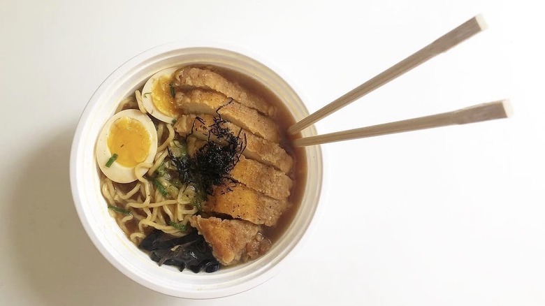 Shoyu ramen with fried chicken, wood ear mushrooms, green onions, and soft-boiled egg