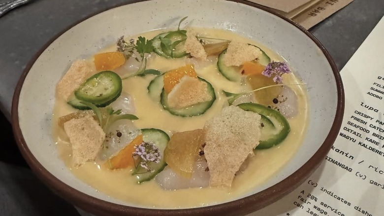 Scallop crudo with kalamansi leche de tigre, rhubarb, purple daikon, and orange