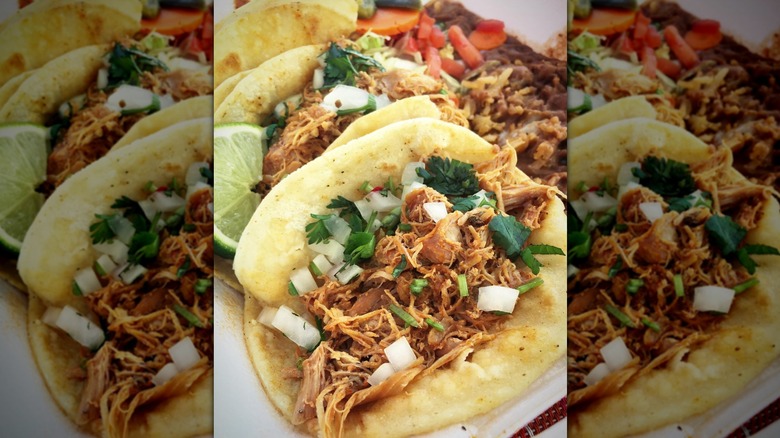 Pulled chicken tacos with onions and cilantro