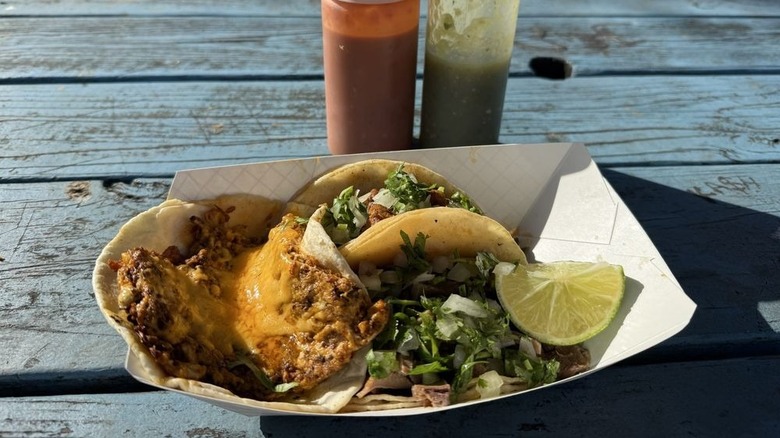 Meat tacos served with salsa and lime