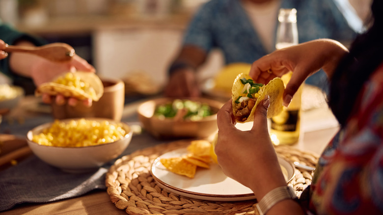 Friends enjoying tacos and other Mexican dishes