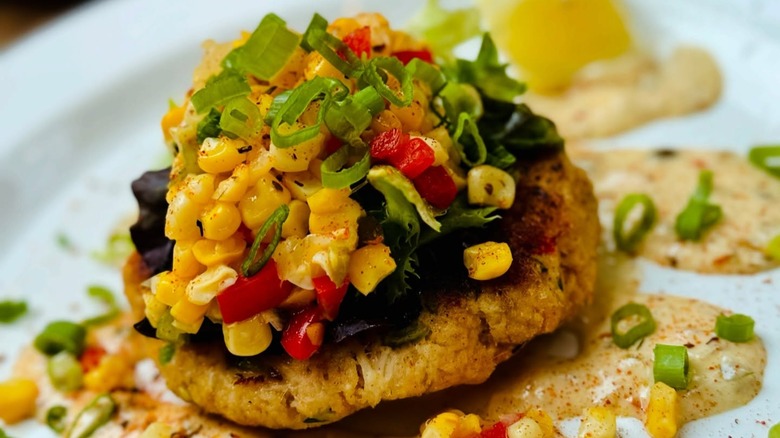 Crab cake with corn, scallions, peppers, and sauce