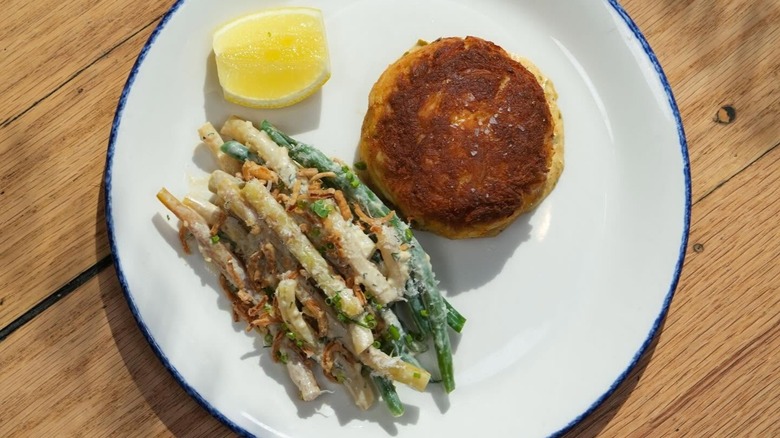 Crab cake with lemon and side of beans