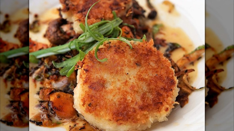 Crab cake with hash and greens