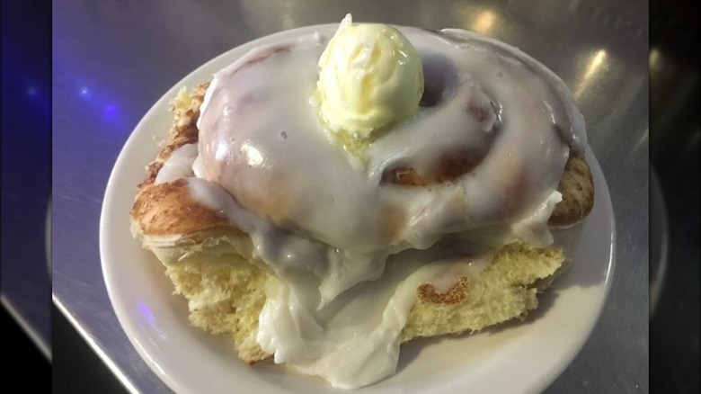 Glazed cinnamon roll on plate