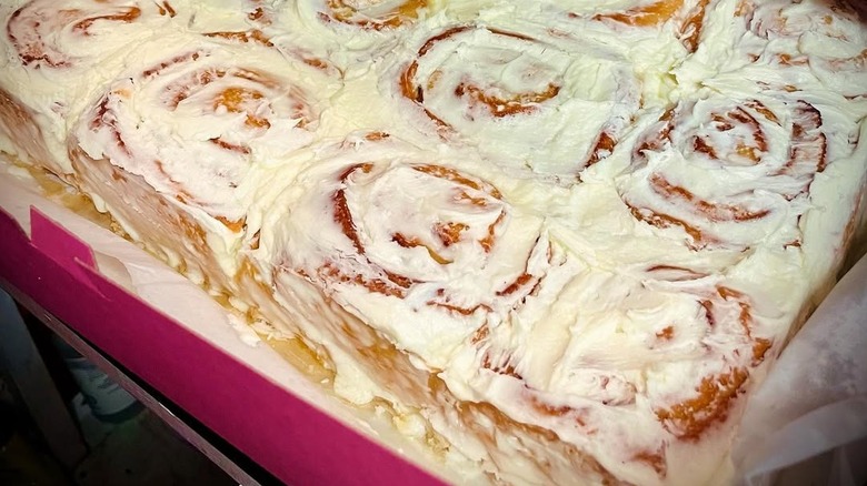 Frosted cinnamon rolls in takeout box