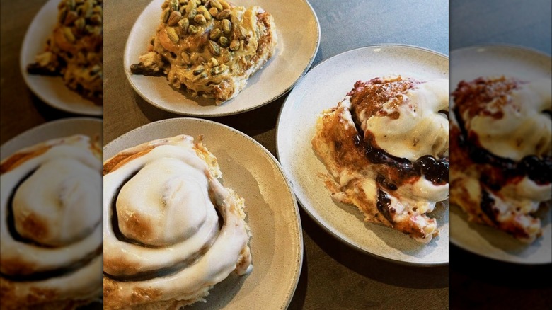Three plates with three different cinnamon rolls