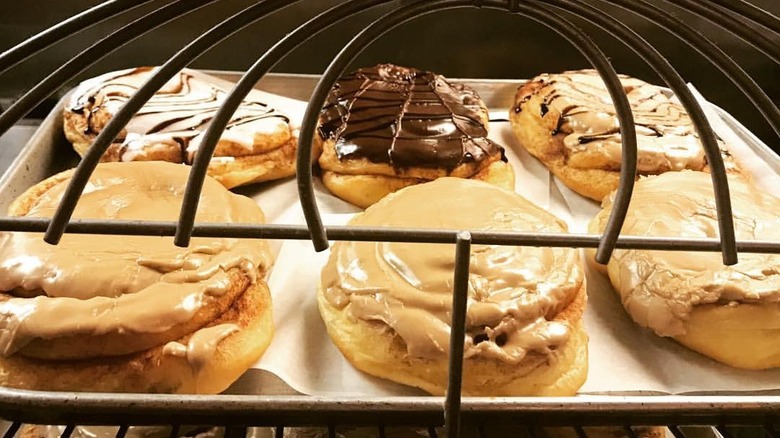 Cinnamon rolls of varying flavors on baking sheet