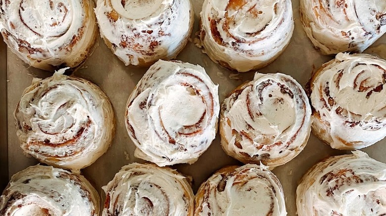 Top view of freshly baked, iced cinnamon rolls