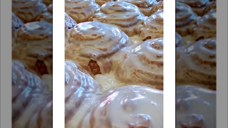 Several generously frosted cinnamon rolls
