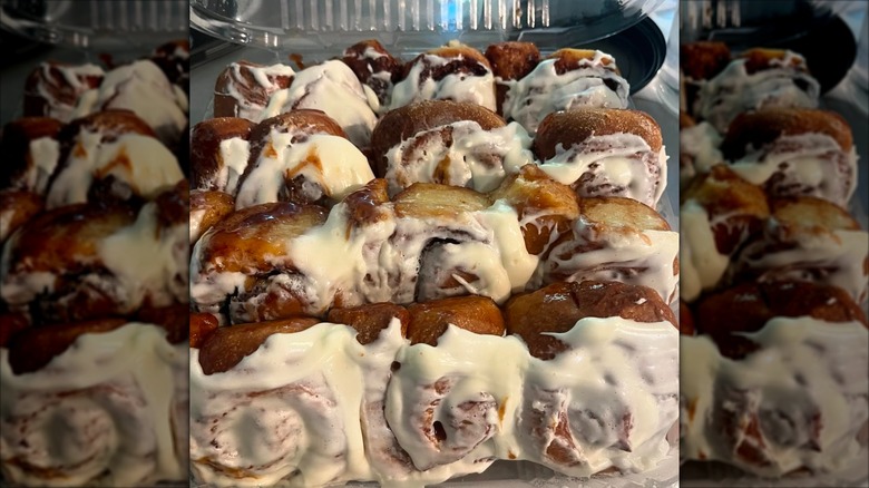 One dozen cinnamon rolls in plastic take-out container