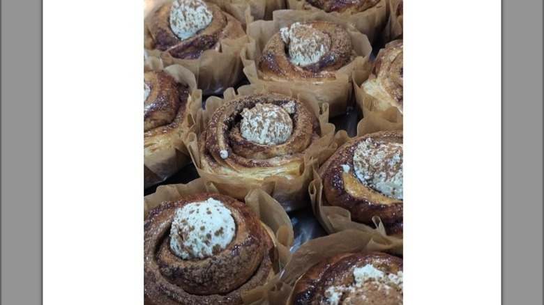 Several individually wrapped cinnamon rolls topped with cream cheese frosting