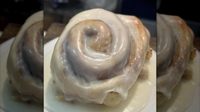 Close-up of frosted cinnamon roll on plate