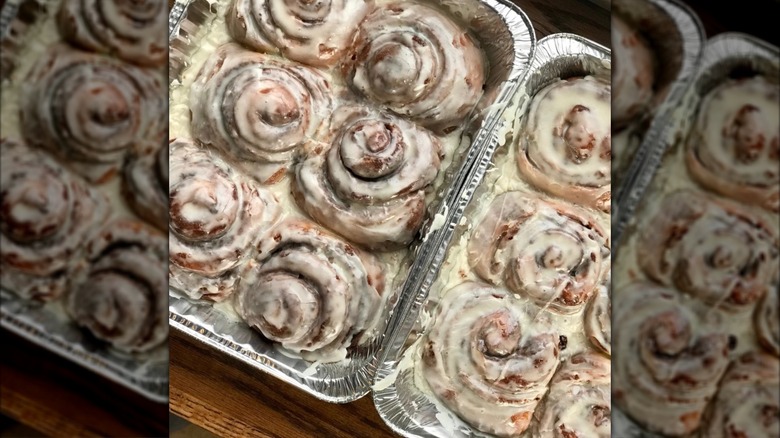 Two foil pans filled with maple cinnamon rolls